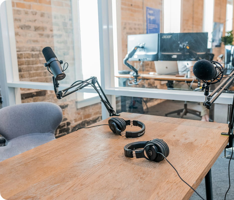 Podcast microphones and mixer on a studio table